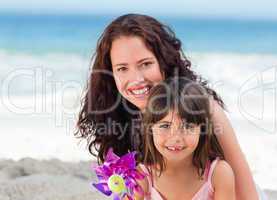 Little girl and her mother with a windmill