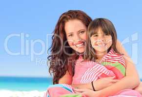 Smiling woman with her daughter in a towel