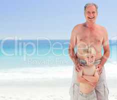 Grandfather with his grandson at the beach