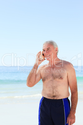 Senior man listening to his shell