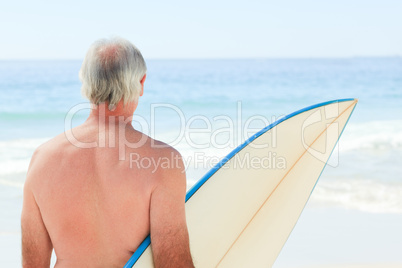 Retired  man with his surfboard