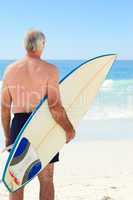Retired  man with his surfboard