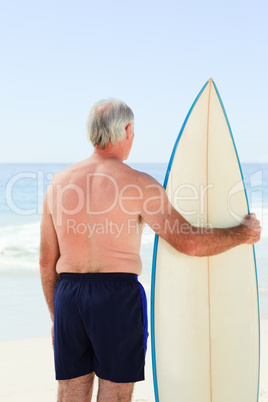 Retired  man with his surfboard