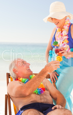 Couple drinking cocktails at the beach
