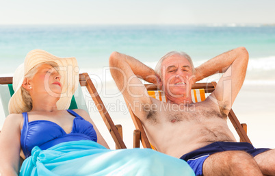 Couple lying in their deck chairs