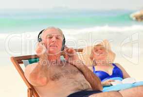 Man listening to music while his wife is sleeping