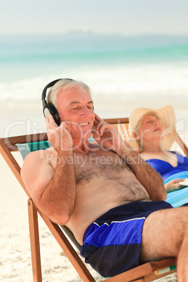 Man listening to music while his wife is sleeping