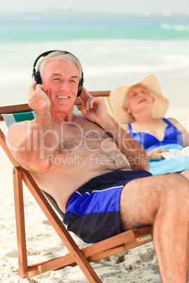 Man listening to music while his wife is sleeping