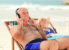 Man listening to music while his wife is sleeping