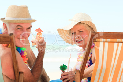 Happy senior couple drinking a cocktail