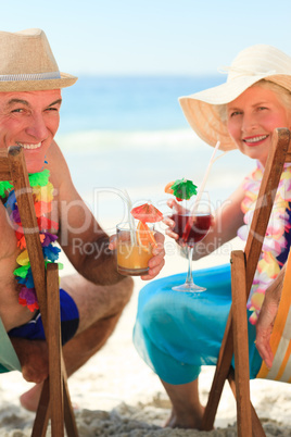 Happy senior couple drinking a cocktail