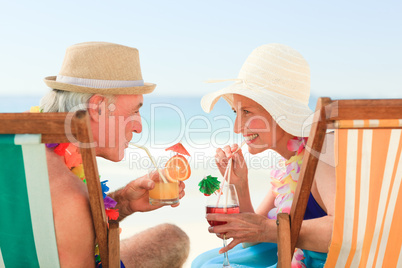 Happy senior couple drinking a cocktail