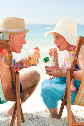 Happy senior couple drinking a cocktail