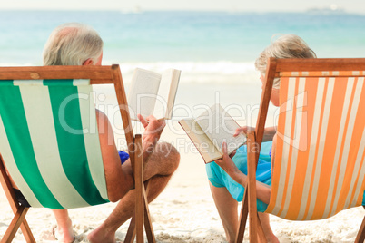 Couple reading at the beach