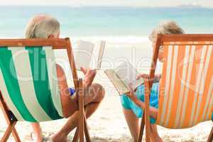 Couple reading at the beach