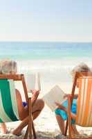 Couple reading at the beach