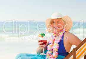 Woman drinking a cocktail in her deck chair