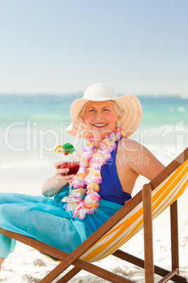 Woman drinking a cocktail in her deck chair