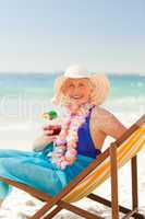 Woman drinking a cocktail in her deck chair