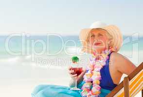 Woman drinking a cocktail in her deck chair