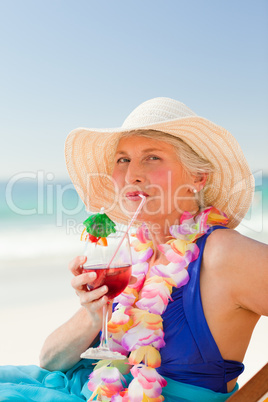 Woman drinking a cocktail in her deck chair