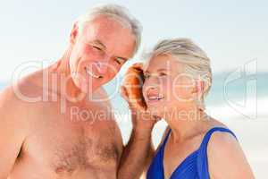 Retired couple listening to their shell