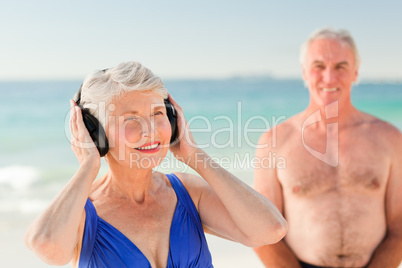 Woman listening to some music at the beach