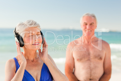 Woman listening to some music at the beach