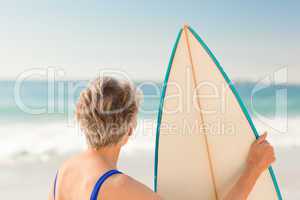 Woman with her surfboard at the beach
