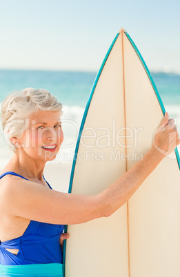 Woman with her surfboard at the beach