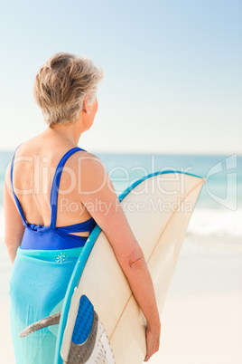 Woman with her surfboard at the beach