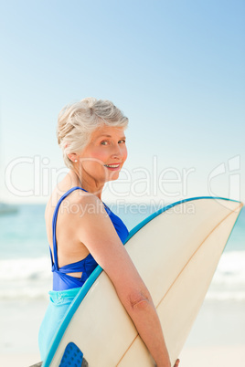 Woman with her surfboard at the beach