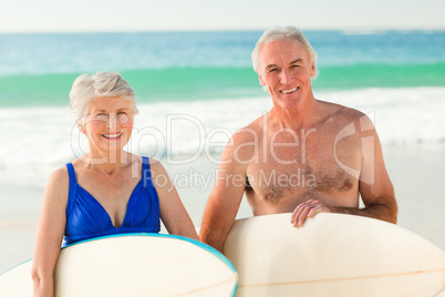 Couple with their surfboard on the beach