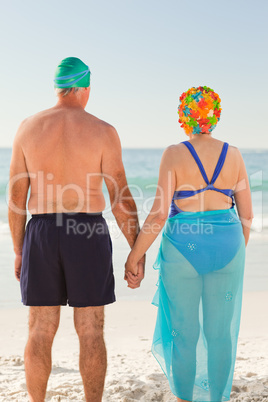 Enamored elderly couple at the beach