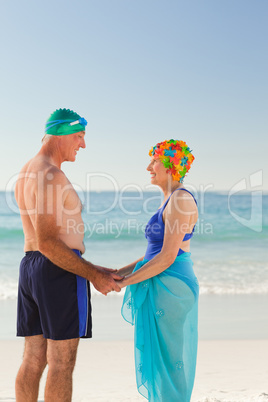 Enamored elderly couple at the beach