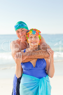 Man hugging his wife at the beach