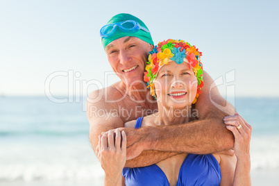 Man hugging his wife at the beach