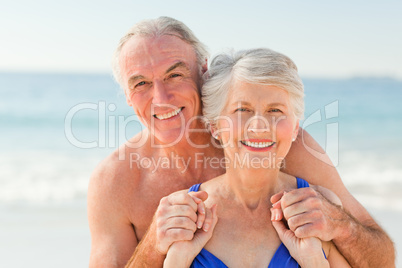 Man hugging his wife at the beach