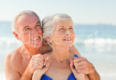 Man hugging his wife at the beach