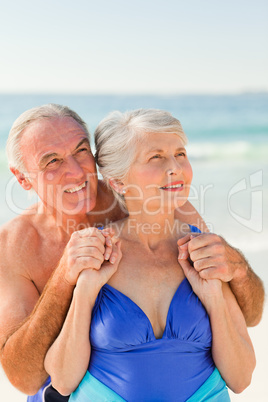 Man hugging his wife at the beach