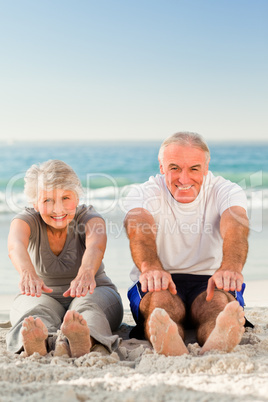 Couple doing their streches at the beach