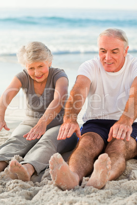 Couple doing their streches at the beach
