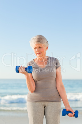 Woman doing her exercises at the beach