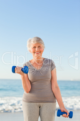 Woman doing her exercises at the beach