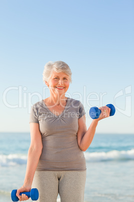 Woman doing her exercises at the beach