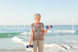Woman doing her exercises at the beach