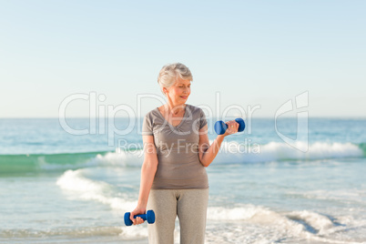 Woman doing her exercises at the beach