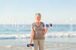 Woman doing her exercises at the beach