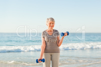 Woman doing her exercises at the beach