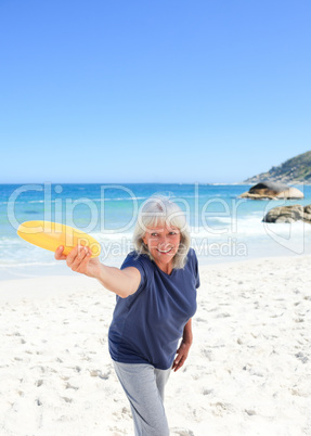 Elderly woman playing freesby